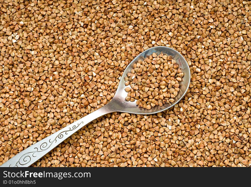 Buckwheat brown  background, close-up, cooking ingredients. Buckwheat brown  background, close-up, cooking ingredients