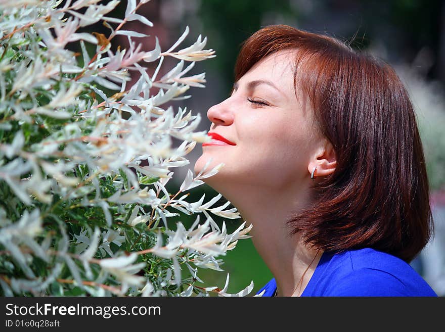 The girl in park feels the smells of spring forgotten for a winter