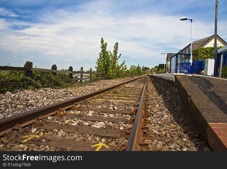 Down the track, platform and station buildings on branch line. Down the track, platform and station buildings on branch line