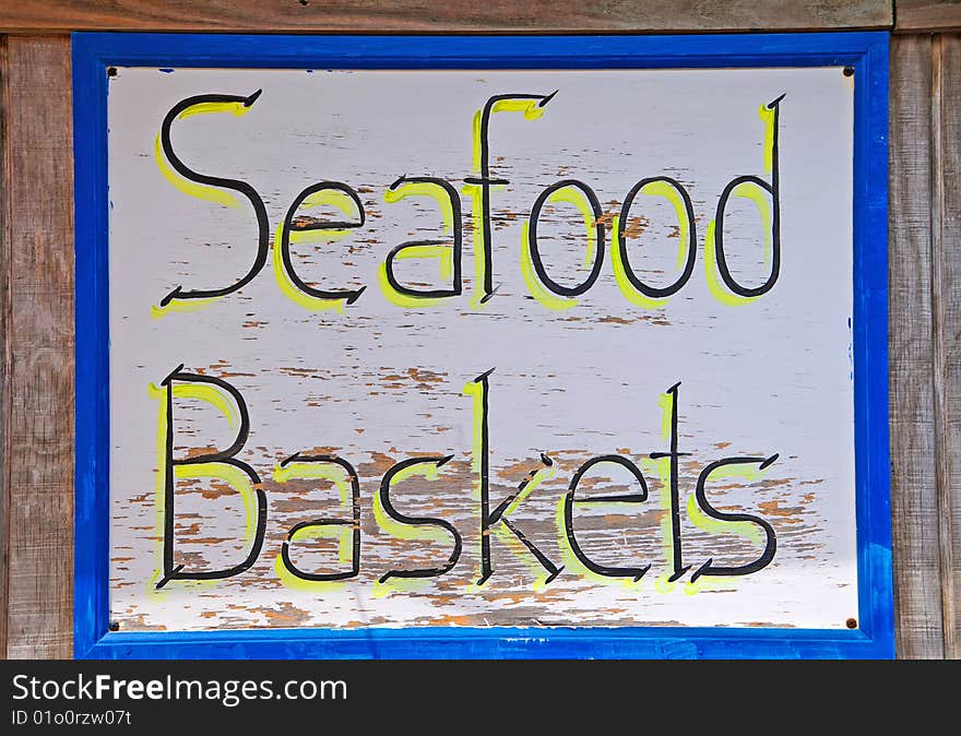 Weathered Resturant Sign advertising Seafood Baskets