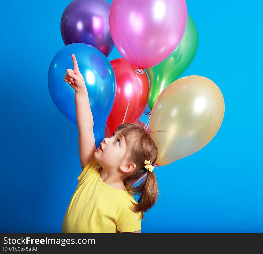 Little girl holding colorful balloons on a blue background