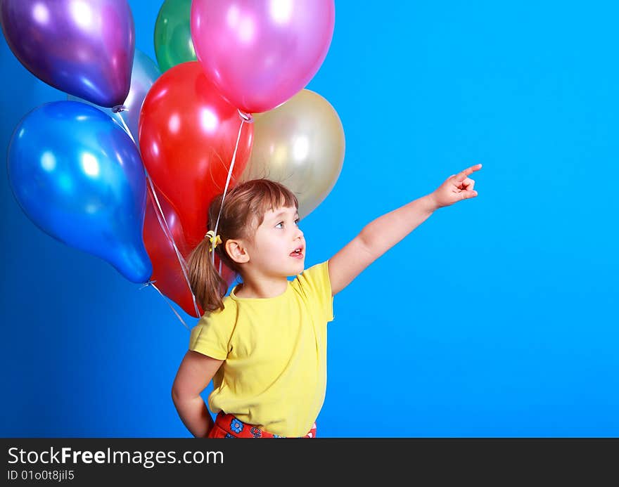 Little girl holding colorful balloons on a blue background