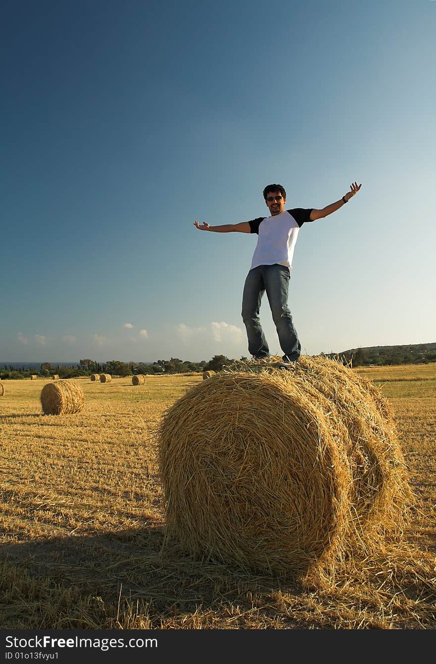 Man standing on haystack