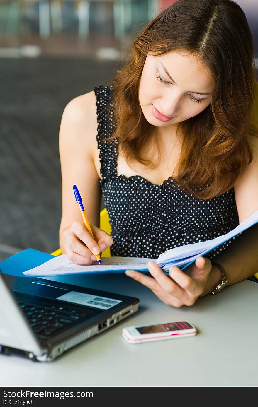 A young pretty caucasian lady using laptop outdoors