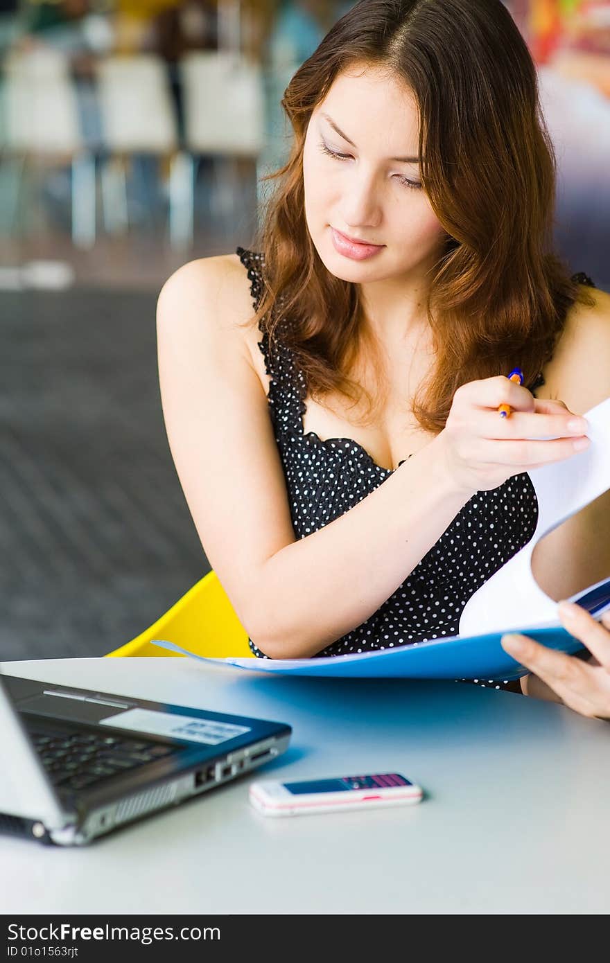 Young pretty caucasian lady using laptop outdoors