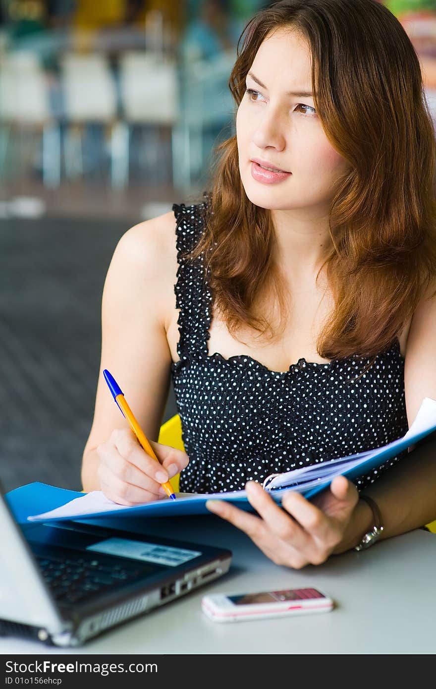 Young pretty caucasian lady using laptop outdoors