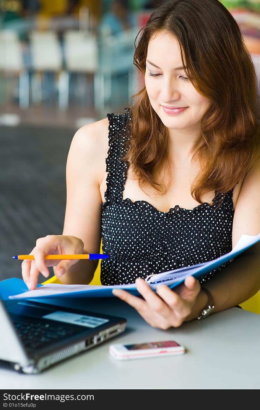 A young pretty caucasian lady using laptop outdoors