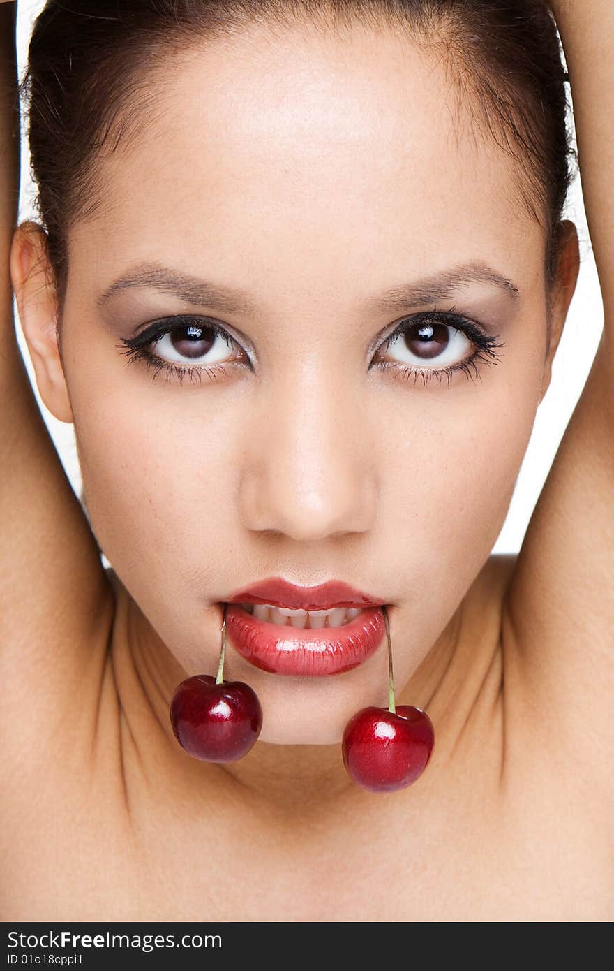 Portrait of woman on white holding red cherries on her lips. Portrait of woman on white holding red cherries on her lips