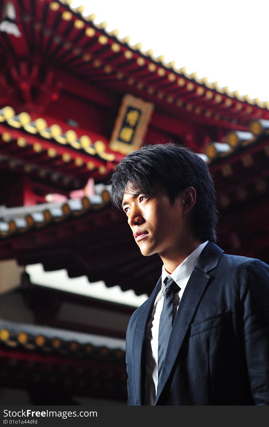 Asian man in business suit in chinese temple. Asian man in business suit in chinese temple