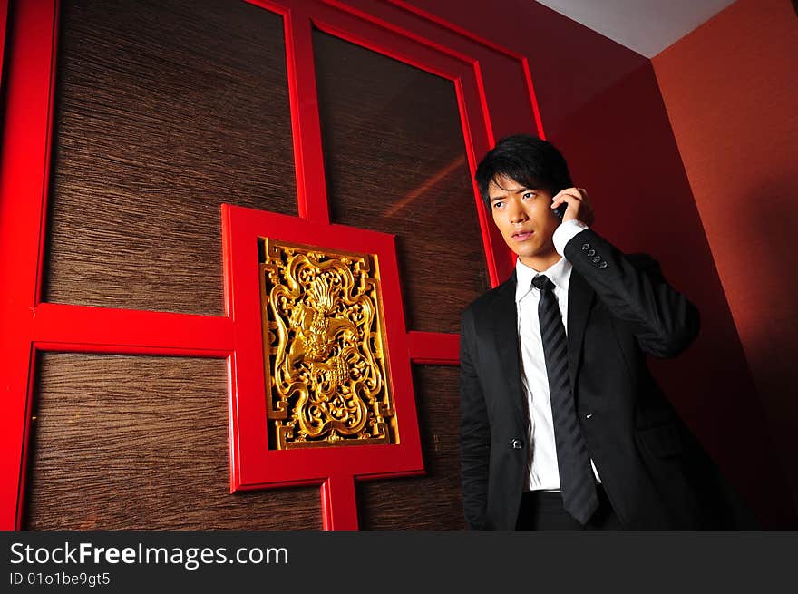 Smart Asian man in business suit in chinese temple. Smart Asian man in business suit in chinese temple