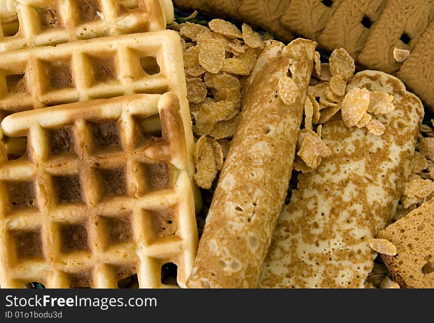 Variety of sweets, waffles pancakes spiced cookies and cornflakes