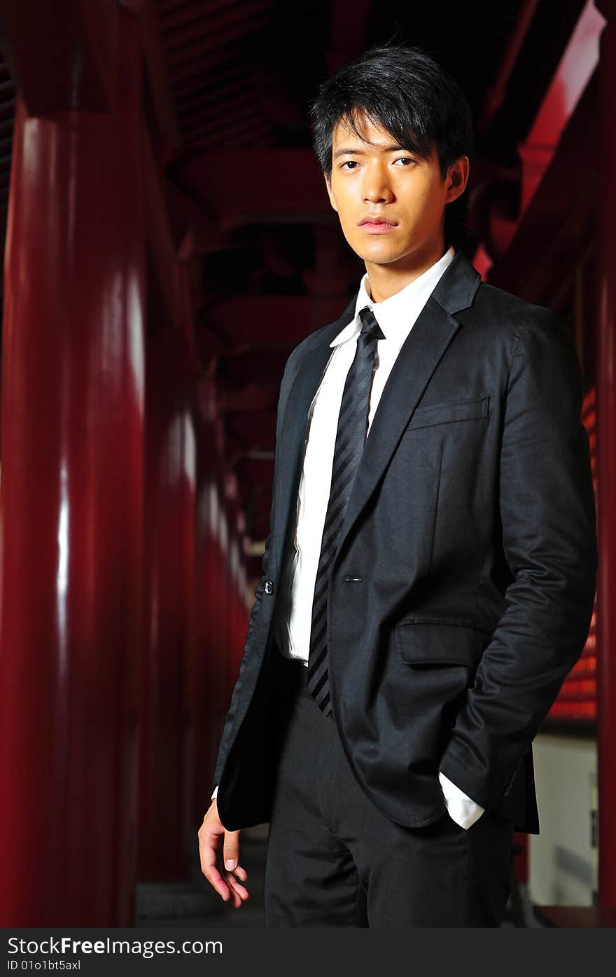 Smart Asian man in business suit in chinese temple. Smart Asian man in business suit in chinese temple