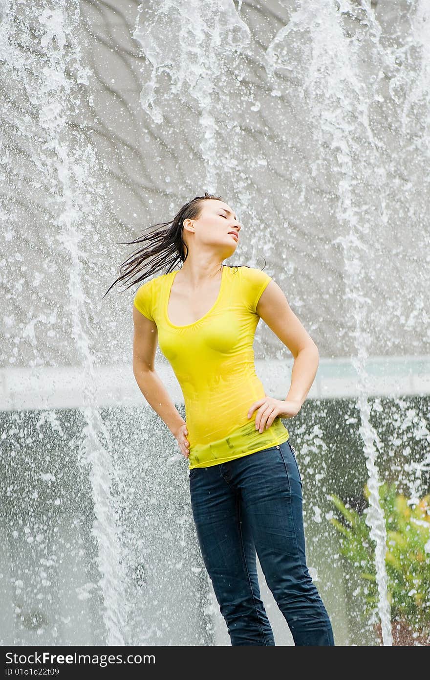 Young Caucasian Girl Playing At Fountain