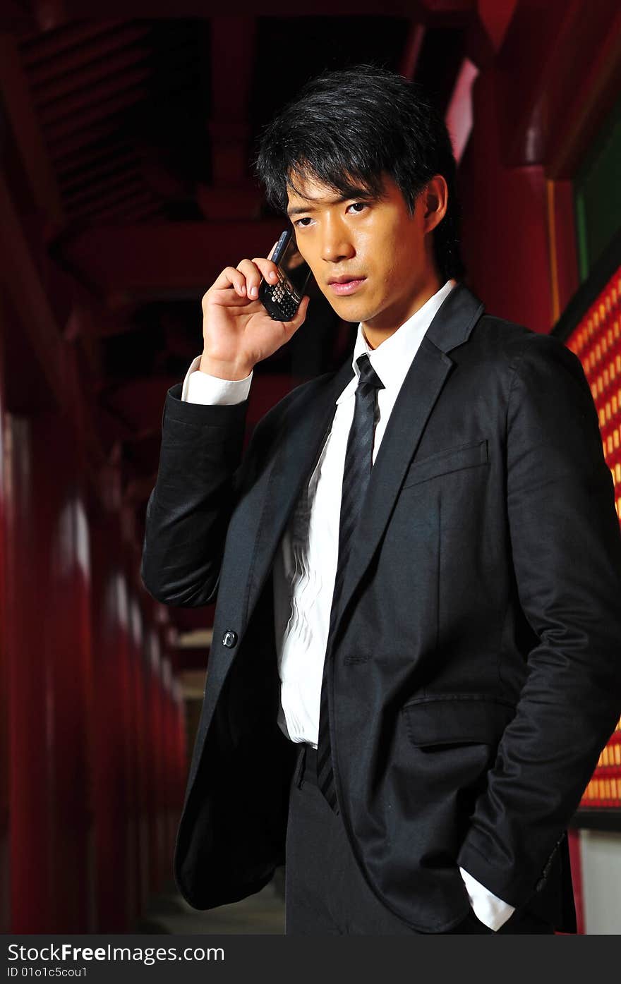 Asian man in business suit with Mobile Phone. Asian man in business suit with Mobile Phone