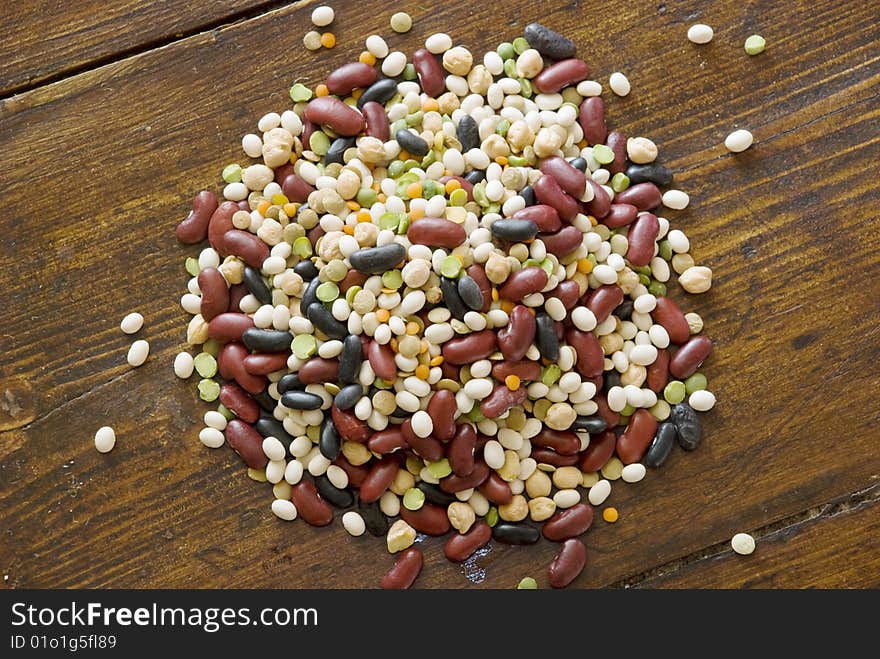 Mix of colorful beans on wood surface. Mix of colorful beans on wood surface