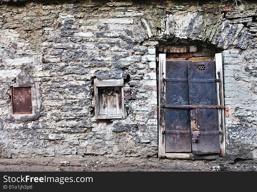 Closed windows on the ancient brick wall