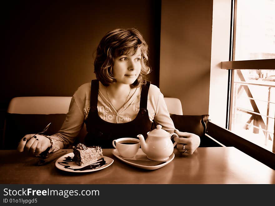 Lonely girl has lunch in small cafe near window. Lonely girl has lunch in small cafe near window