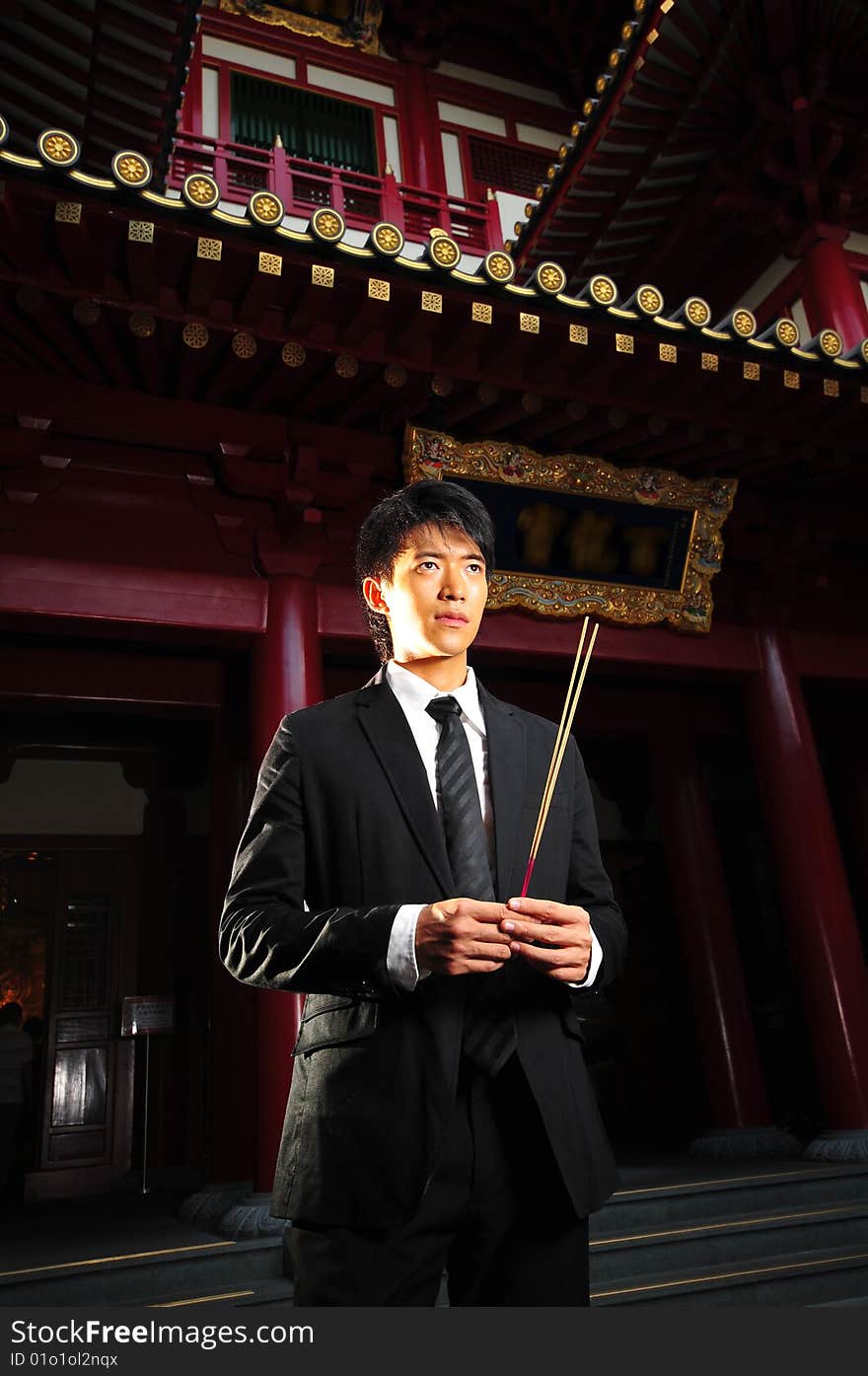 Asian man in business suit in chinese temple. Asian man in business suit in chinese temple