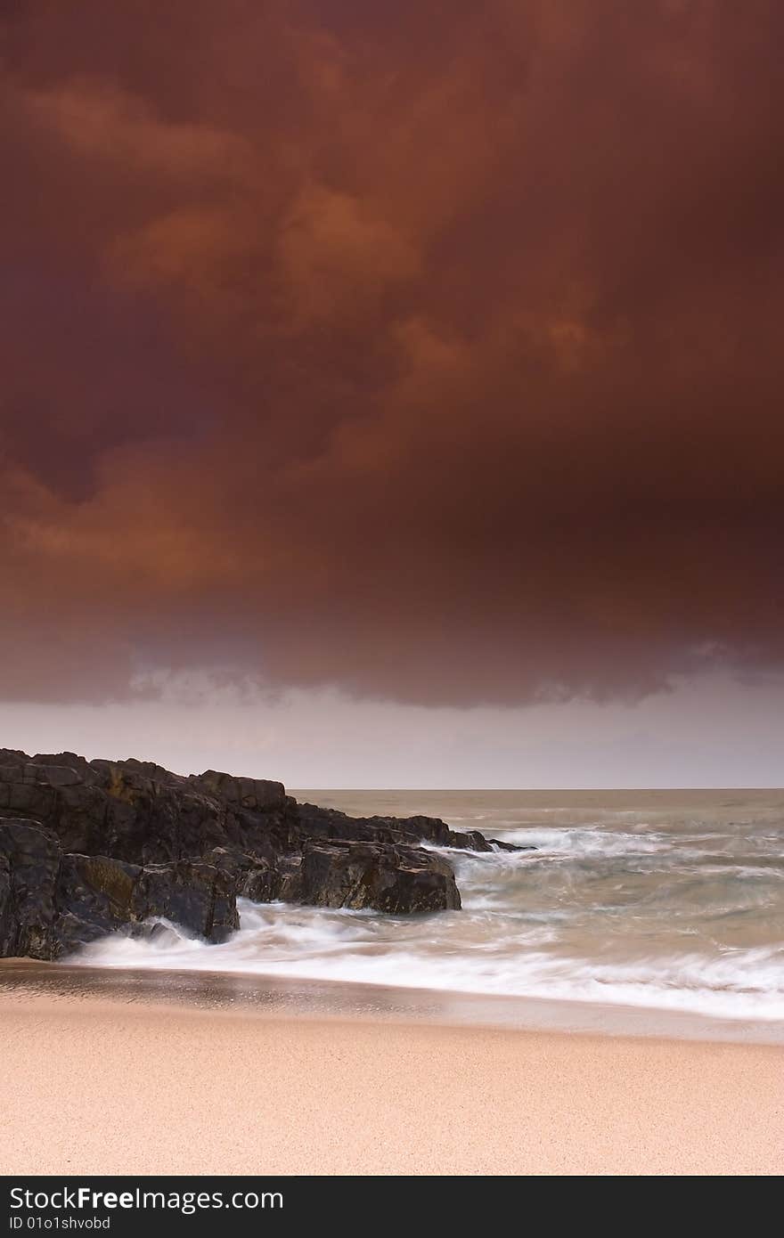 Storm brewing over rocky shore and sandy beach of Winkelspruit near Durban