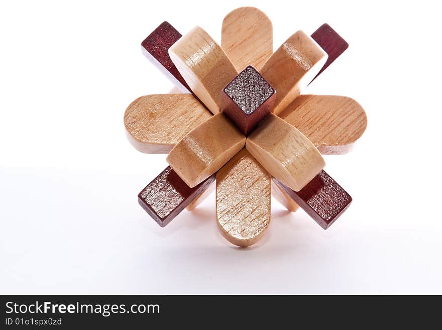 Two colored wooden burr puzzle assembled on white. Two colored wooden burr puzzle assembled on white