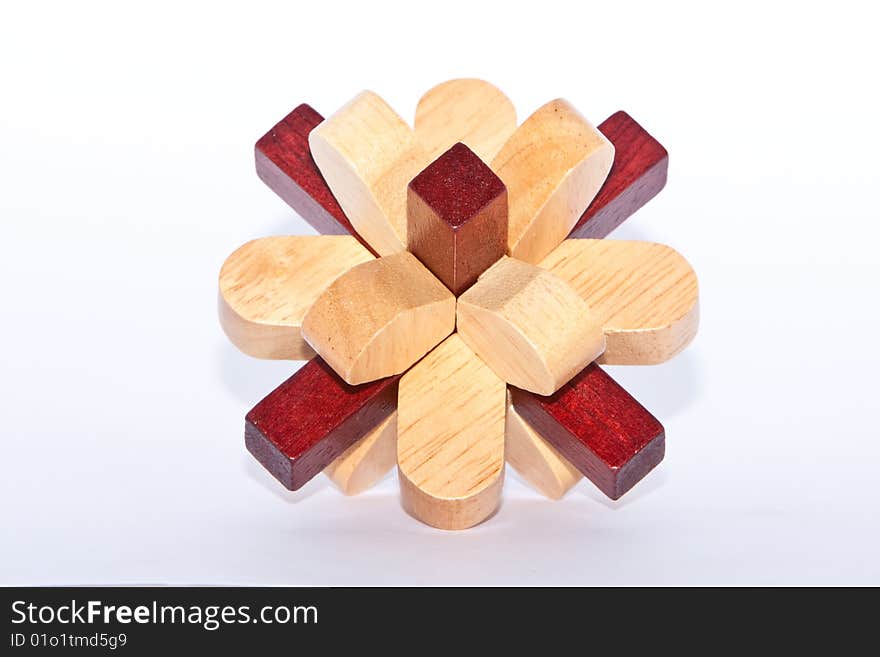 Two colored wooden burr puzzle assembled on white. Two colored wooden burr puzzle assembled on white