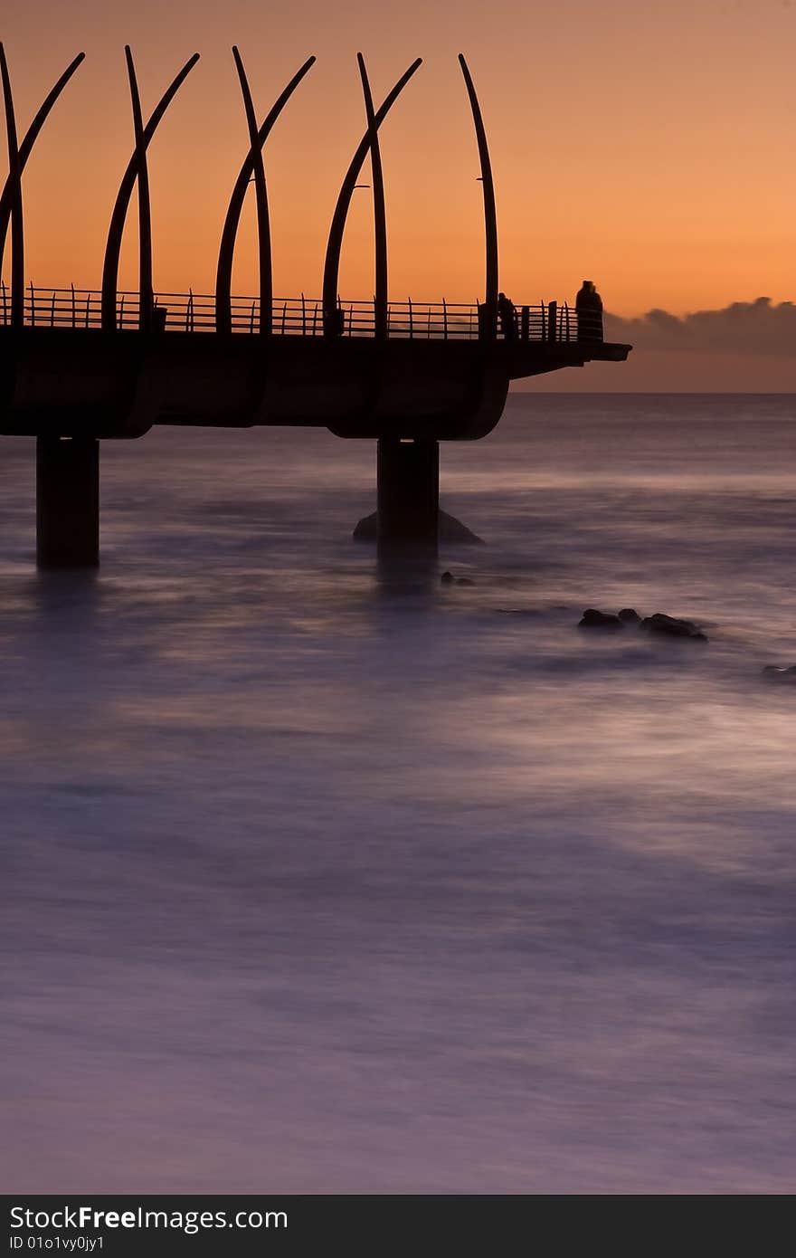 Umhlanga Pier at sunrise with oragne glow. Umhlanga Pier at sunrise with oragne glow