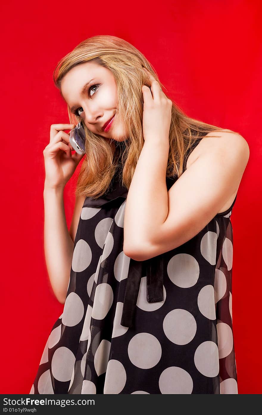 Smiling blonde speaking on phone isolated