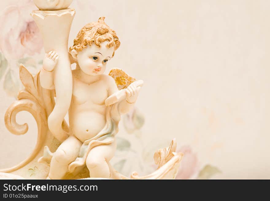 Cherub with book and golden wings