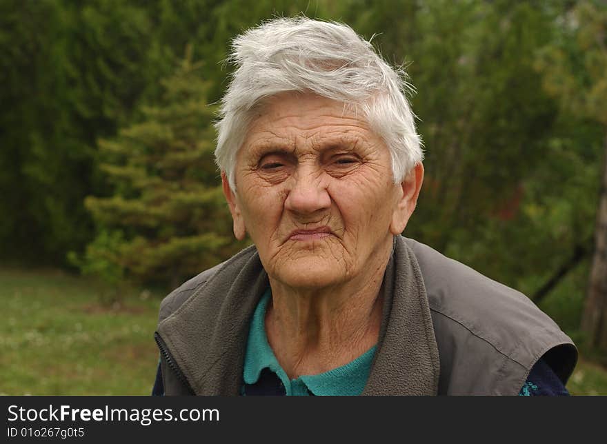 An old woman with glasses. An old woman with glasses.