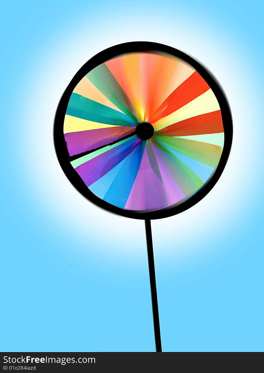 Plastic colourful pinwheel on the blue background