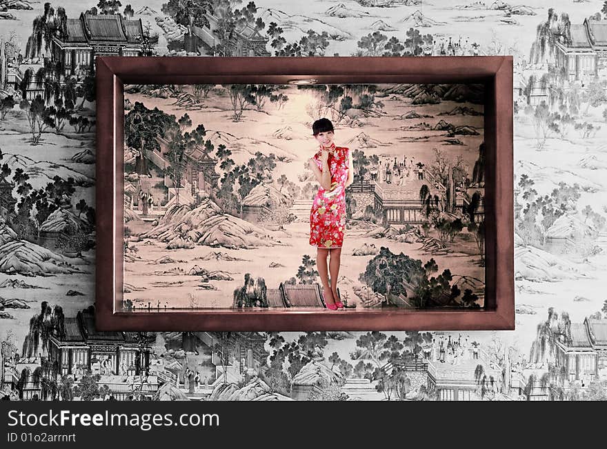 A frame is decorated on the Chinese ancient painting background wall. A Chinese girl in traditional dress stands in the picture. A frame is decorated on the Chinese ancient painting background wall. A Chinese girl in traditional dress stands in the picture.