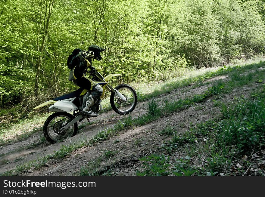 An enduro rider fast moving on motocross.