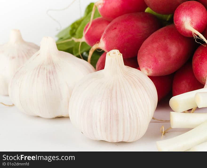 Spring onions, garlic, lettuce and radish bunch on the white background