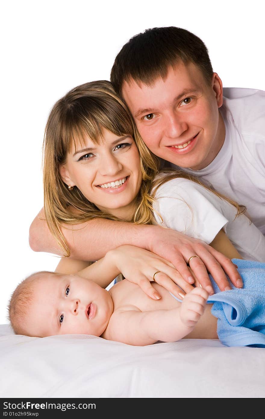 mother and father holding their little child studio shot