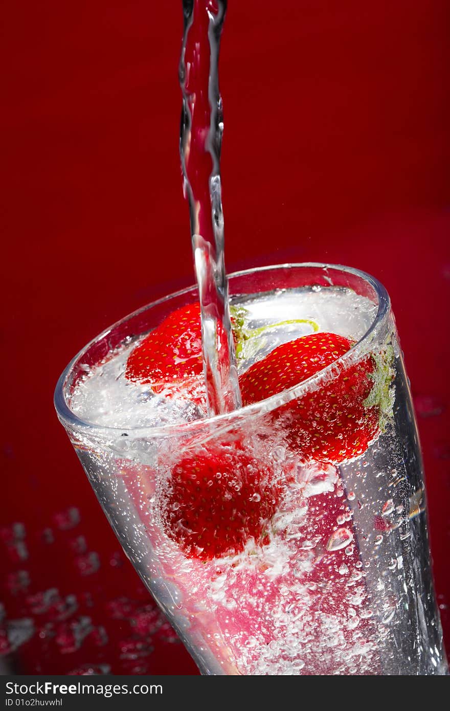 Juicy strawberry in a glass with ice. Juicy strawberry in a glass with ice