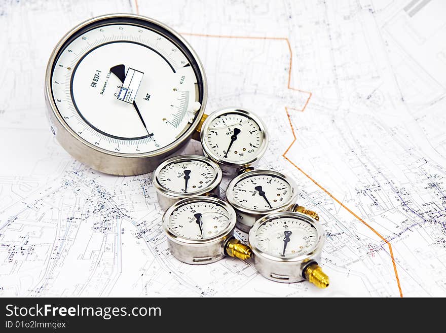 Manometer pressure pipes for water, with the background a map of the pipes. Manometer pressure pipes for water, with the background a map of the pipes