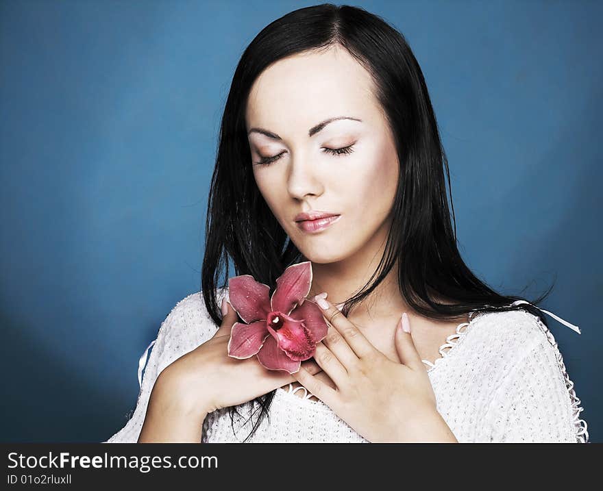 Portrait of young woman with  pink orchid. Portrait of young woman with  pink orchid