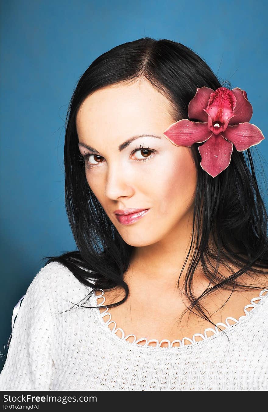 Portrait of young woman with  pink orchid. Portrait of young woman with  pink orchid