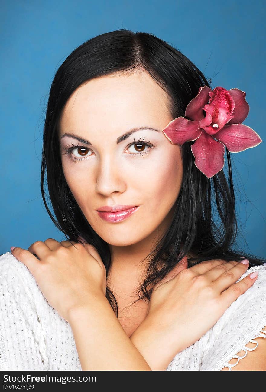 Portrait of young woman with  pink orchid. Portrait of young woman with  pink orchid