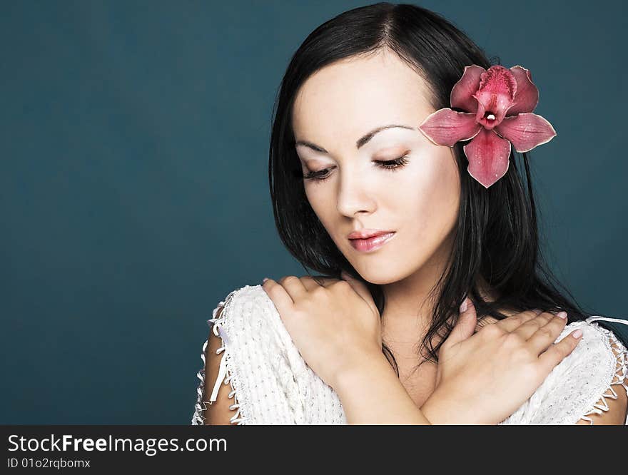 Portrait of young woman with pink orchid. Portrait of young woman with pink orchid