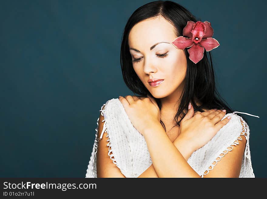 Portrait of young woman with pink orchid. Portrait of young woman with pink orchid