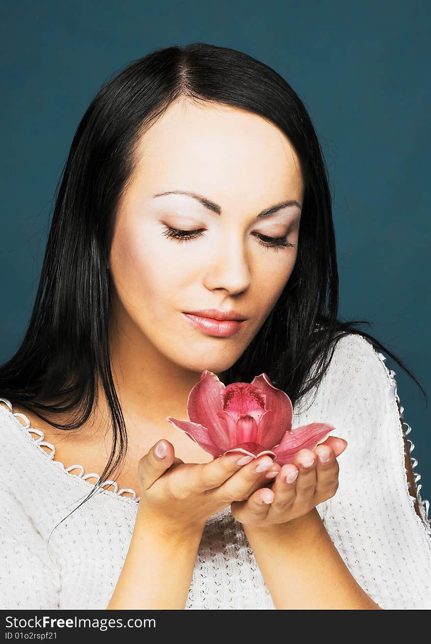 Portrait of young woman with pink orchid. Portrait of young woman with pink orchid