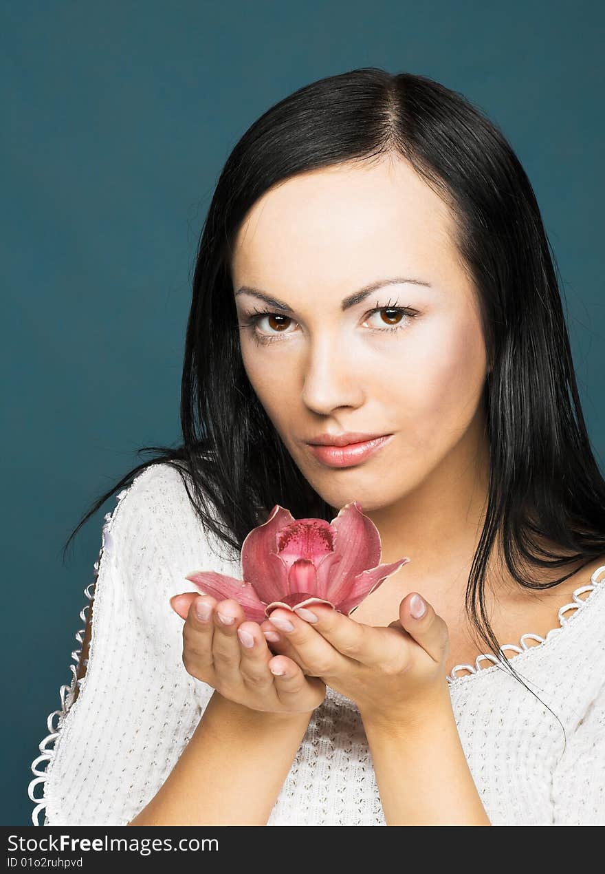 Portrait of young woman with  pink orchid. Portrait of young woman with  pink orchid