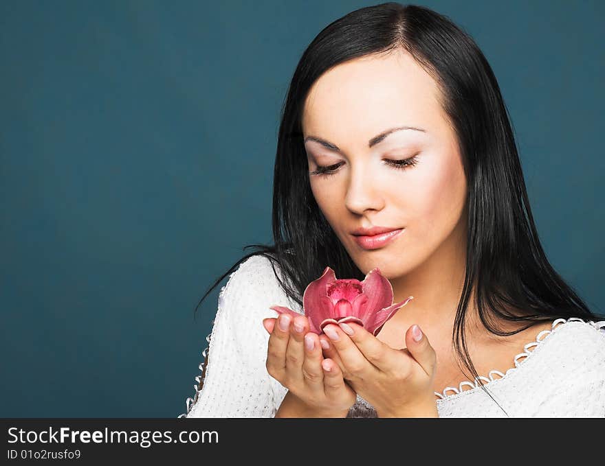 Portrait of young woman with  pink orchid. Portrait of young woman with  pink orchid