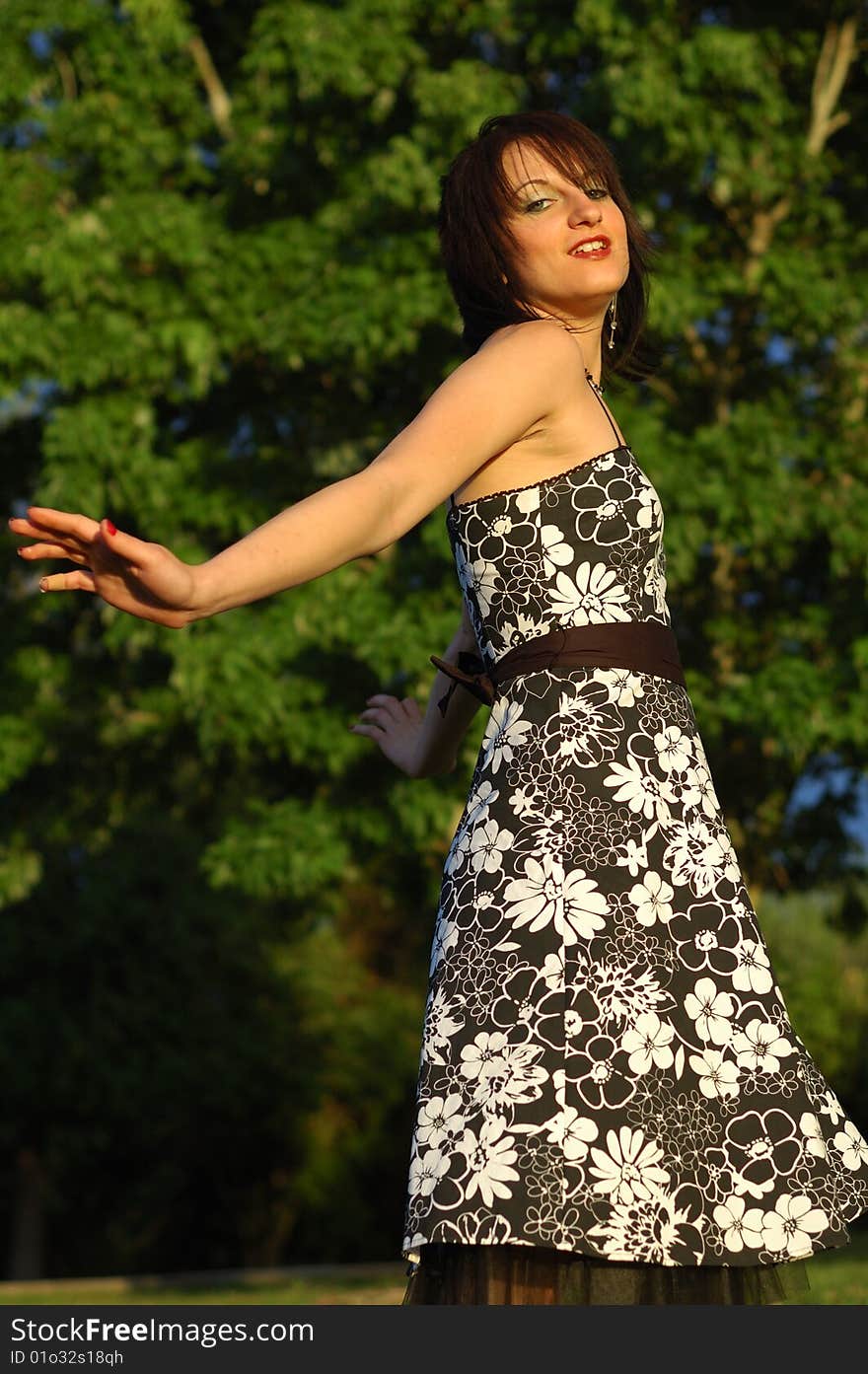 Happy looking young woman wearing a floral print dress