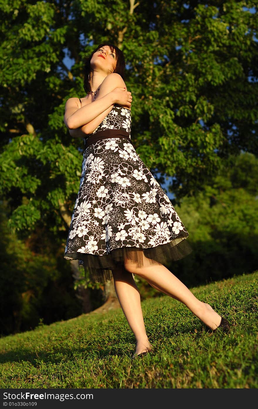 Happy looking young woman wearing a floral print dress