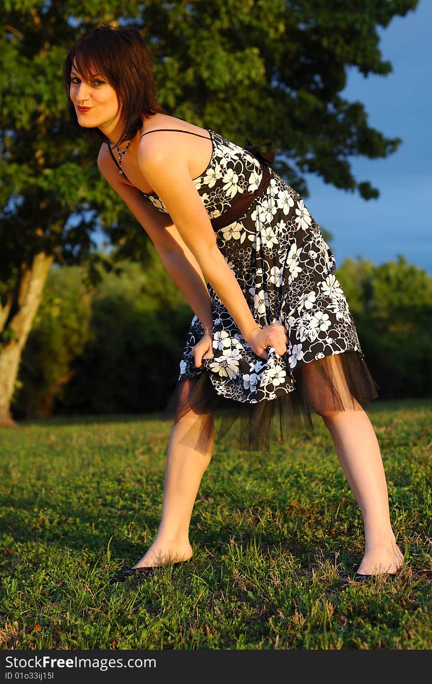 Happy looking young woman wearing a floral print dress