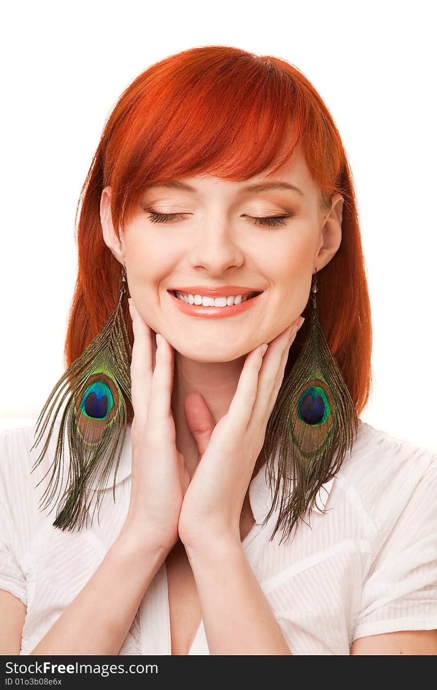 Portrait of young beautiful redhead woman with peacock earrings and closed eyes