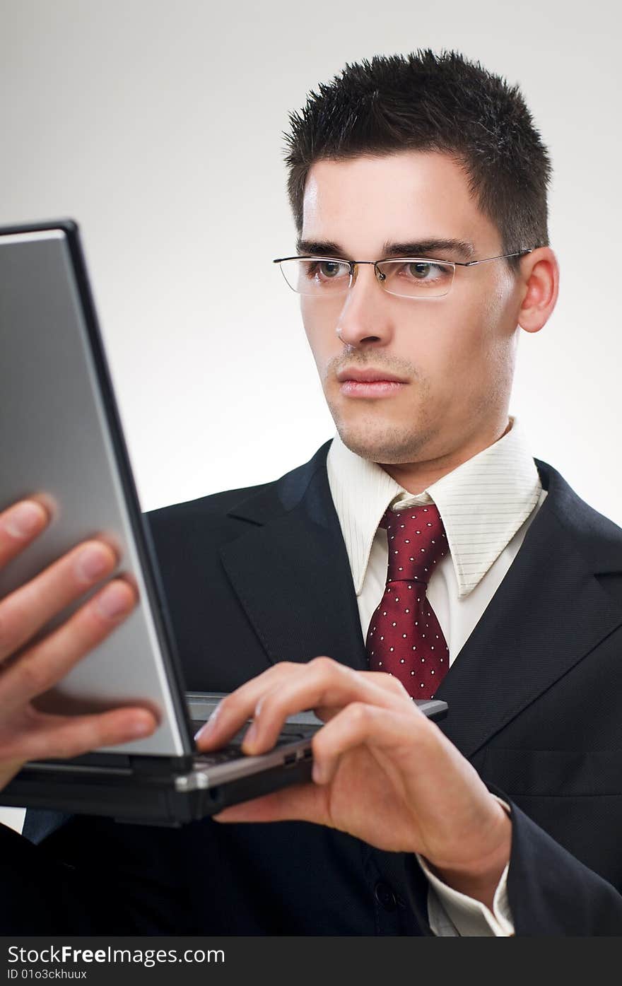 Young business man working on a laptop close up