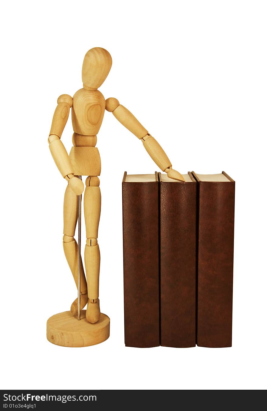 Wooden dummy and pile of old books isolated on a white background